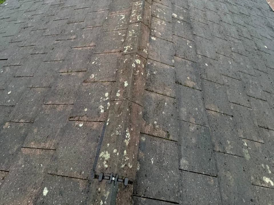 The same roof after cleaning, moss cleared from both slopes and the ridge