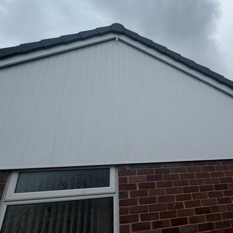 New white uPVC gable cladding with dry verge after replacement